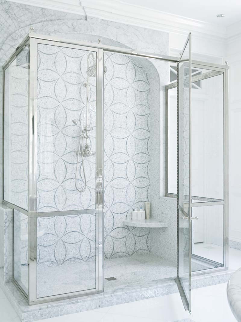 Fully-framed silver stall shower enclosure with thick glass, super-sized hinges, and matching silver shower hardware.
