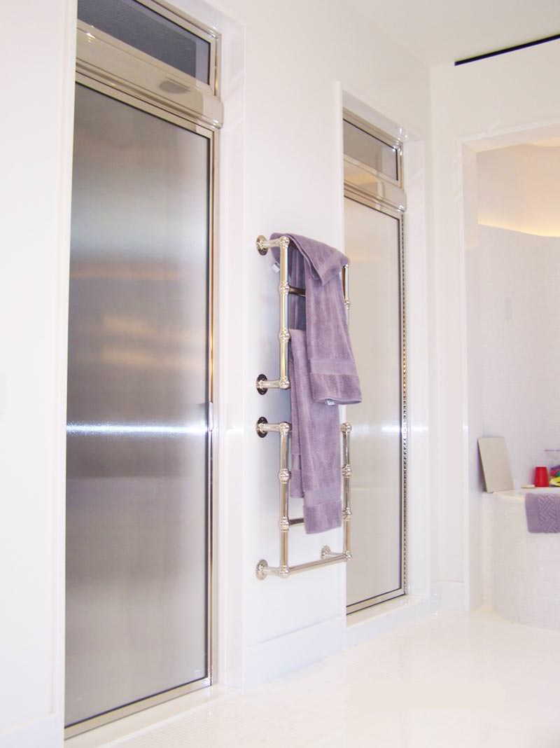 Two fully-sealed, acid-etched glass steam shower enclosure doors with a towel handle between them.