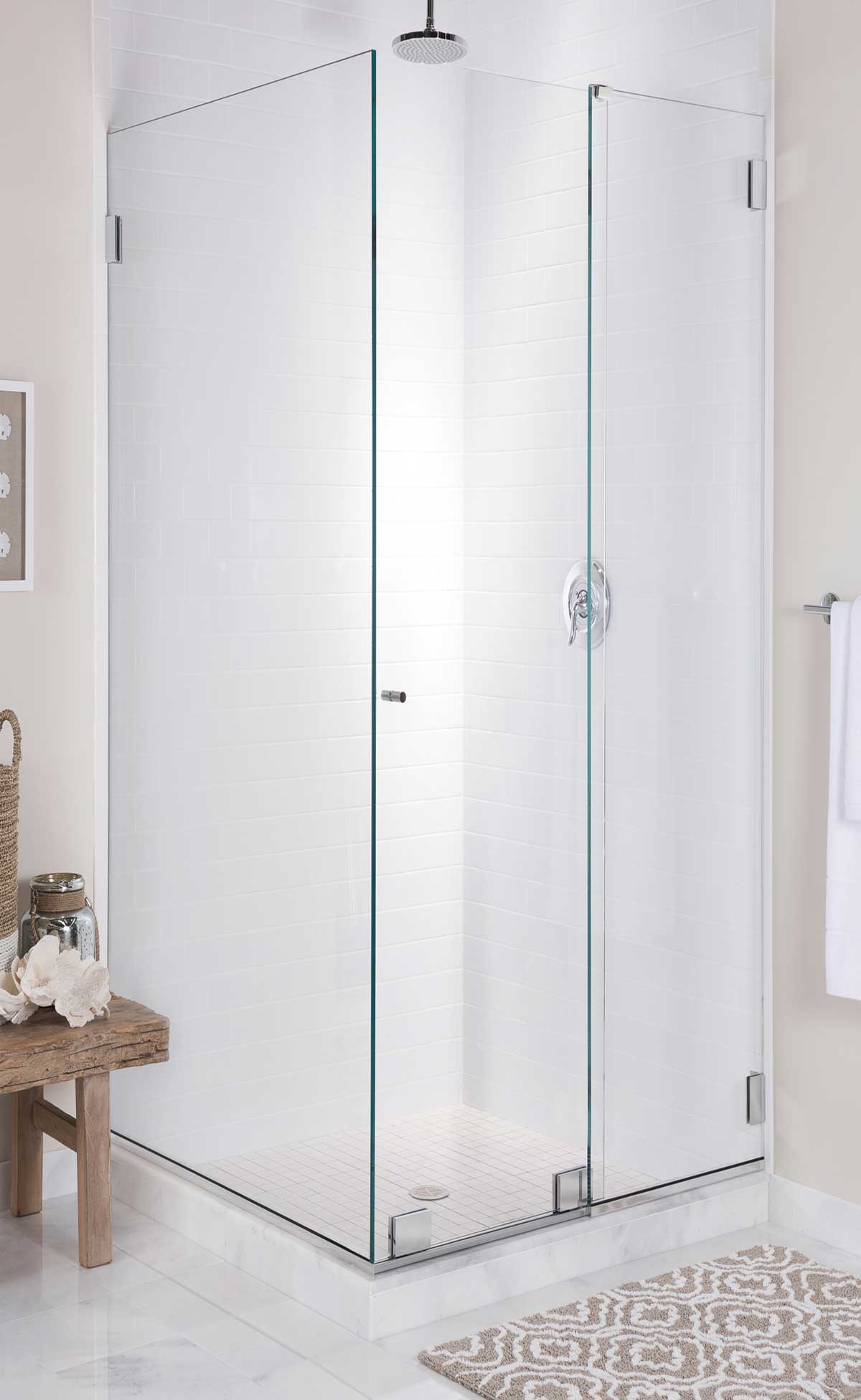 90 degree glass shower enclosure without any framing. Minimalist knob on a sliding door with matching silver shower hardware.